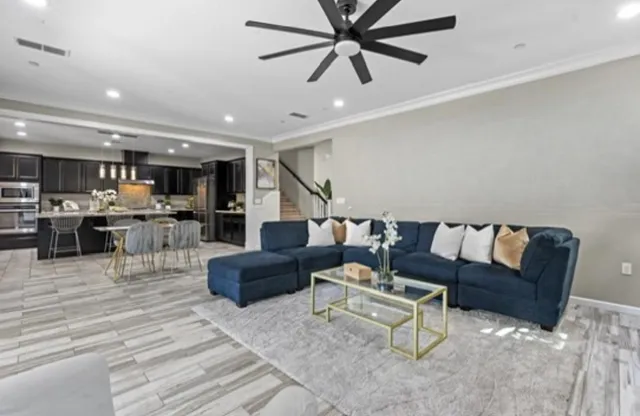 a living room with furniture and kitchen view