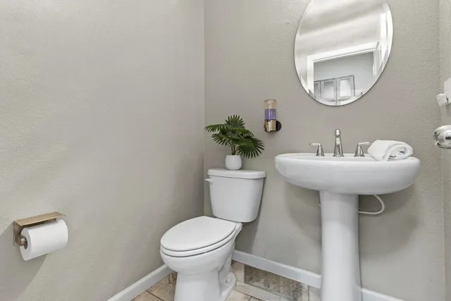 a bathroom with a sink toilet and a mirror