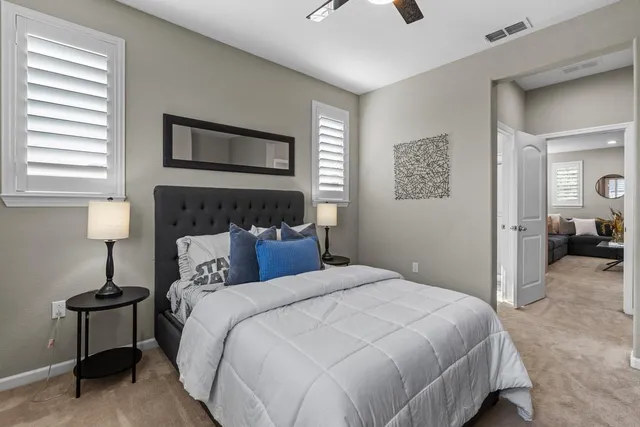 a bedroom with a bed and a painting on the wall