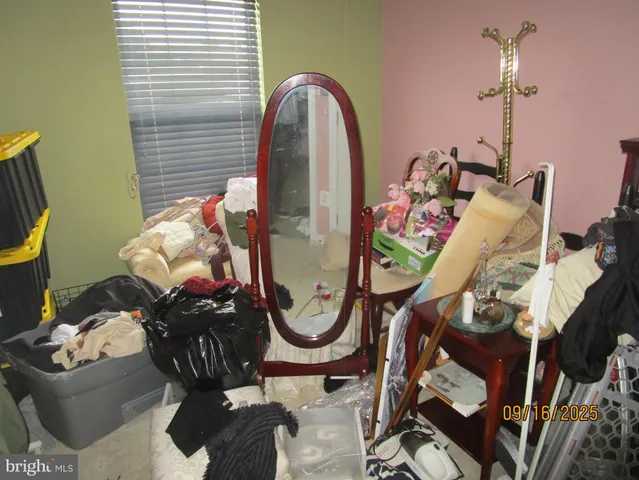 a view of a patio with couches and a fire pit and wooden fence
