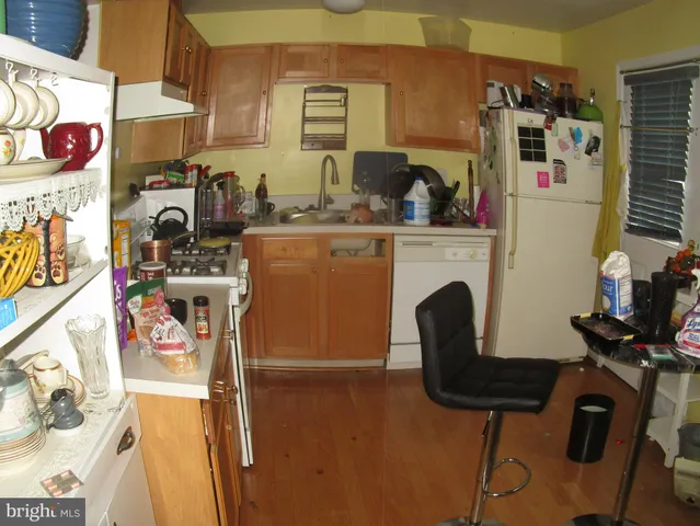 a kitchen with a sink a stove and cabinets