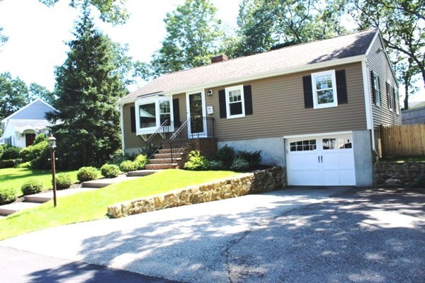 15 Melvin Road Arlington, MA 02474 - Photo 1 of 26 a front view of a house with a yard and garage