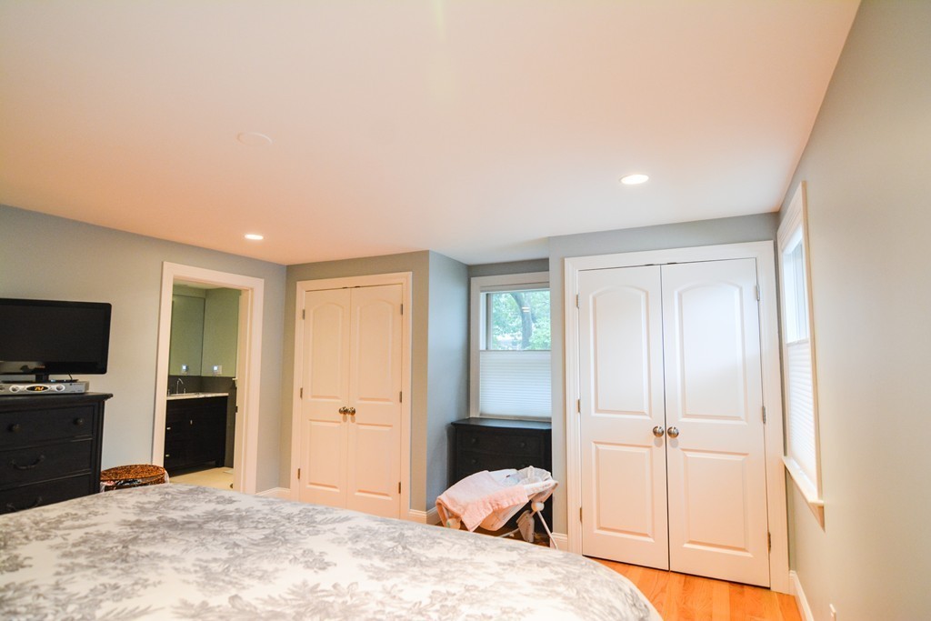 15 Melvin Road Arlington, MA 02474 - Photo 13 of 26 a bedroom with a bed and a flat screen tv