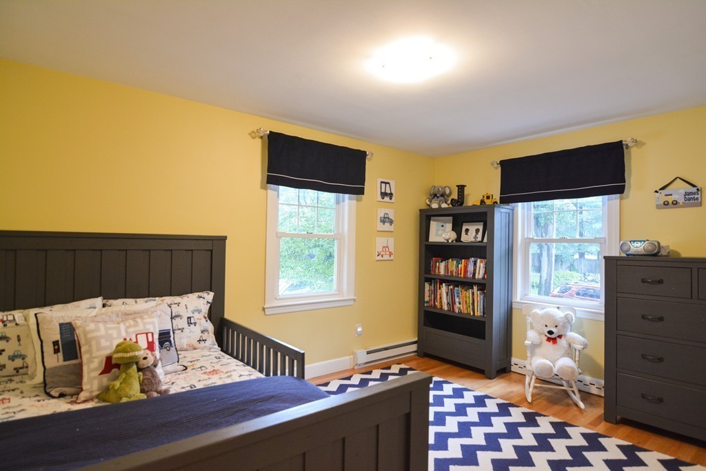 15 Melvin Road Arlington, MA 02474 - Photo 16 of 26 a bedroom with a bed and wooden floor