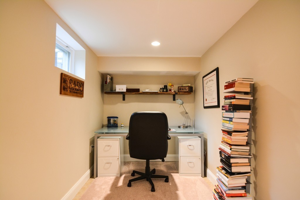 15 Melvin Road Arlington, MA 02474 - Photo 20 of 26 a living room with furniture and a fireplace