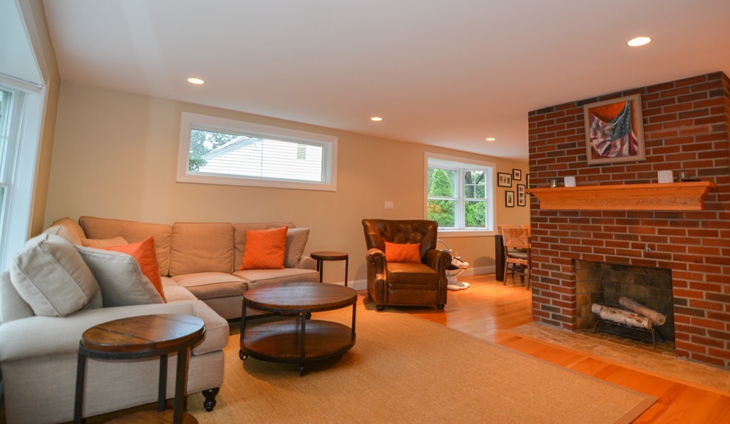 15 Melvin Road Arlington, MA 02474 - Photo 2 of 26 a living room with furniture a fireplace and a table