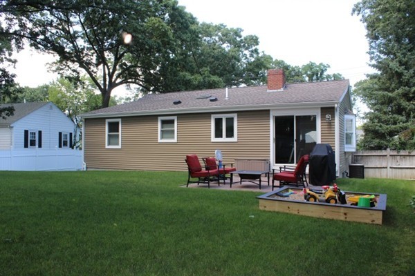 15 Melvin Road Arlington, MA 02474 - Photo 26 of 26 a view of a backyard with table and chairs potted plants and a large tree