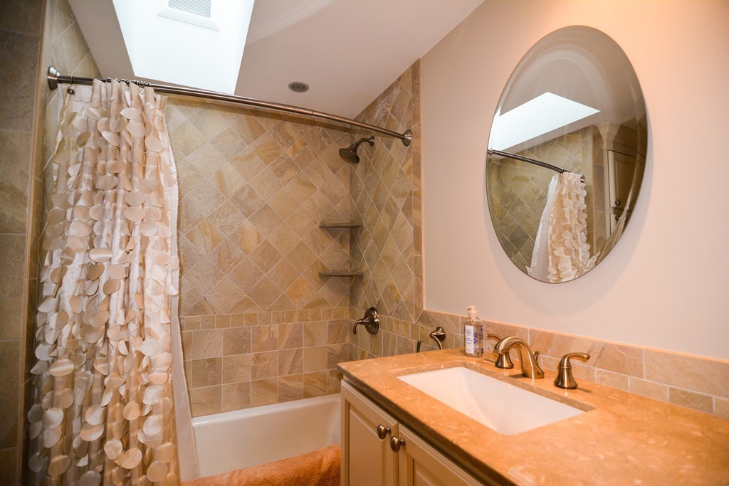 15 Melvin Road Arlington, MA 02474 - Photo 10 of 26 a bathroom with a sink and a mirror
