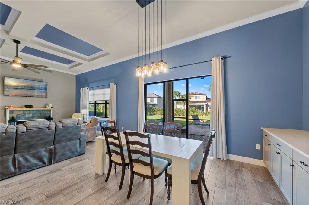 4914 Seton Way Immokalee, FL 34142 - Photo 12 of 46 Dining area featuring coffered ceiling, light wood-type flooring, ornamental molding, and a ceiling fan