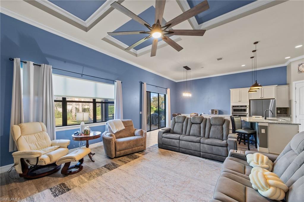 4914 Seton Way Immokalee, FL 34142 - Photo 15 of 46 Living area with a ceiling fan, wood finished floors, and ornamental molding