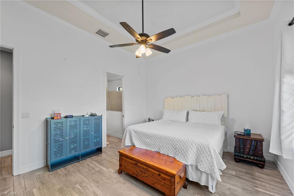 4914 Seton Way Immokalee, FL 34142 - Photo 27 of 46 Bedroom with light wood-style flooring, crown molding, and ceiling fan