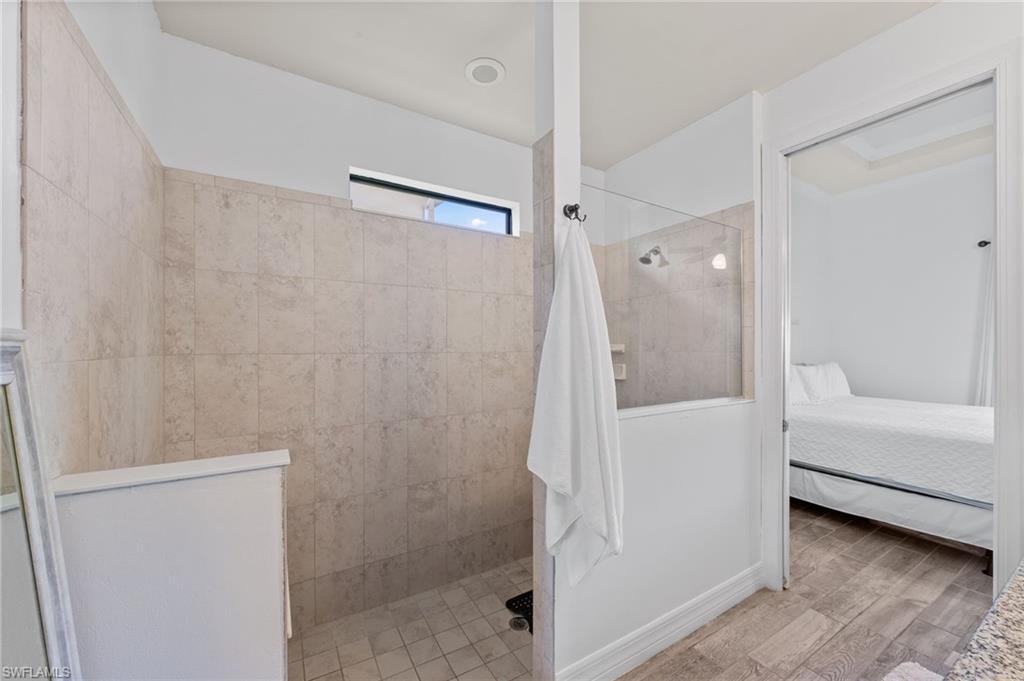 4914 Seton Way Immokalee, FL 34142 - Photo 29 of 46 Ensuite bathroom featuring walk in shower and light wood-type flooring