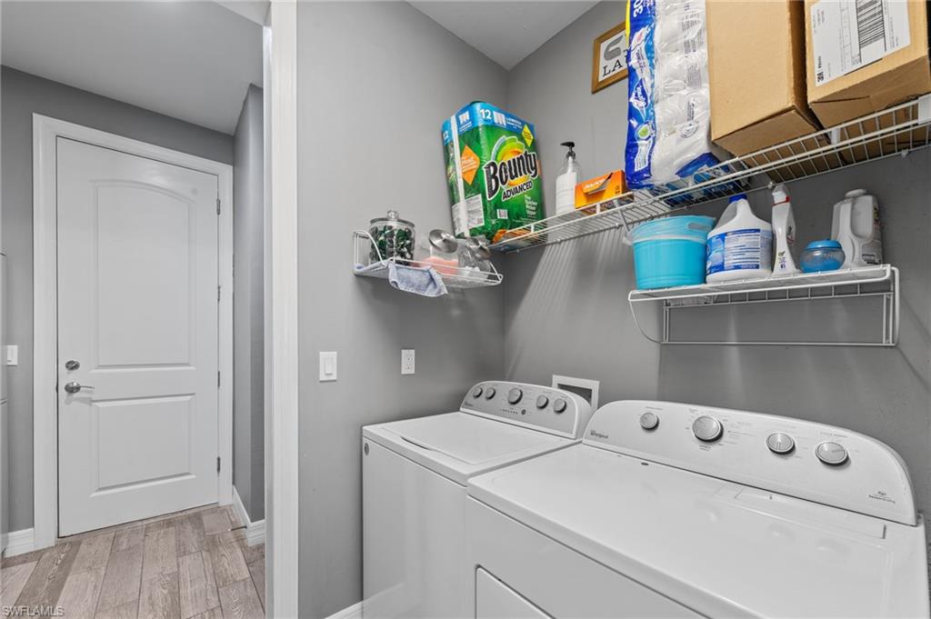 4914 Seton Way Immokalee, FL 34142 - Photo 31 of 46 Laundry room featuring light wood-type flooring and washer and dryer