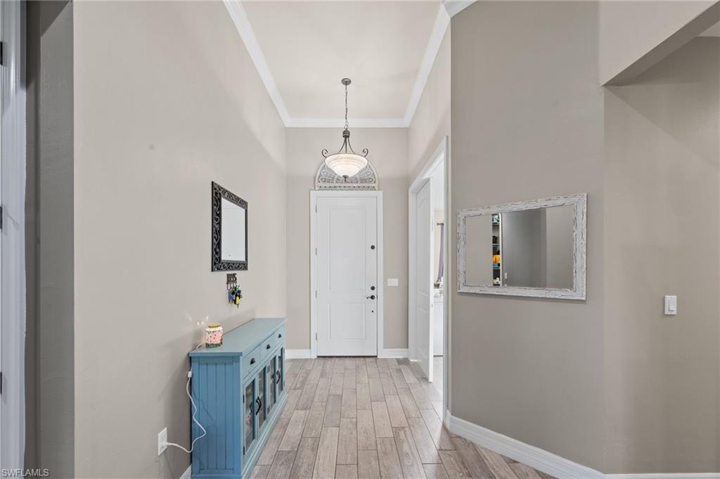 4914 Seton Way Immokalee, FL 34142 - Photo 4 of 46 Entryway featuring ornamental molding and wood finish floors