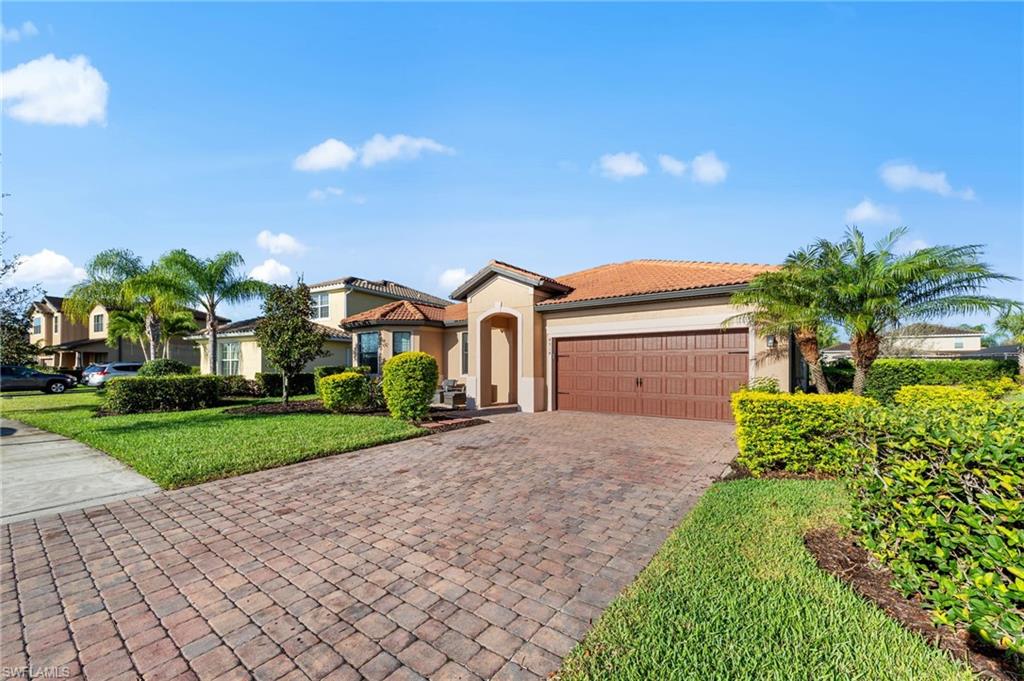 4914 Seton Way Immokalee, FL 34142 - Photo 45 of 46 Mediterranean / spanish-style home featuring stucco siding, decorative driveway, a garage, and a tiled roof