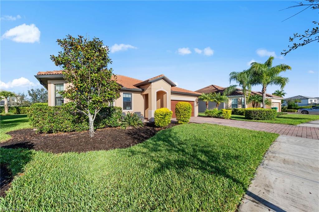 4914 Seton Way Immokalee, FL 34142 - Photo 46 of 46 Mediterranean / spanish house with a front lawn, a tile roof, driveway, and stucco siding