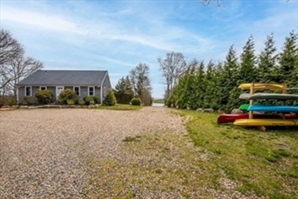 2 Sassamon Trail Marion, MA 02738 - Photo 3 of 10 a backyard of a house with table and chairs