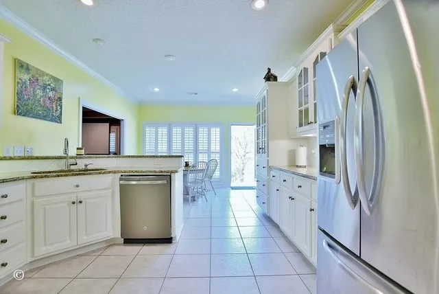 a kitchen with cabinets and stainless steel appliances