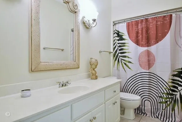 a bathroom with a sink a mirror and a toilet
