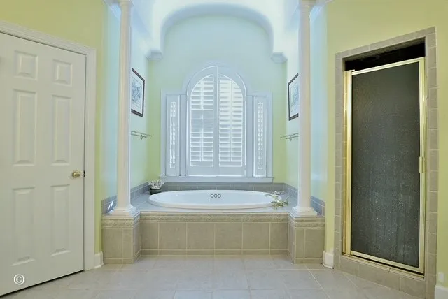 a spacious bathroom with a bathtub and a shower