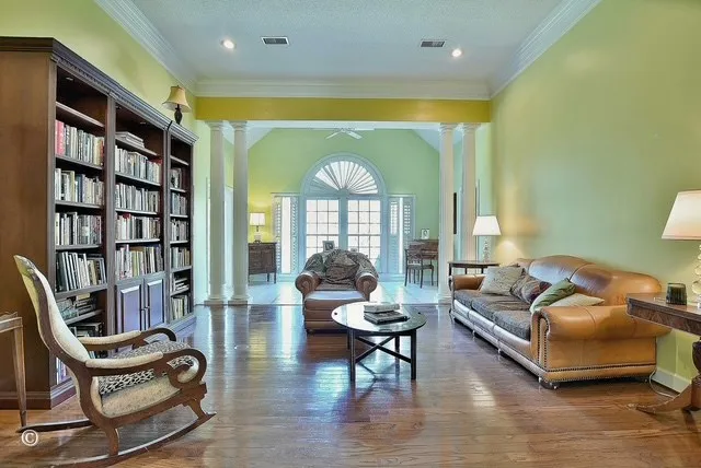 a living room with furniture a rug and a large window