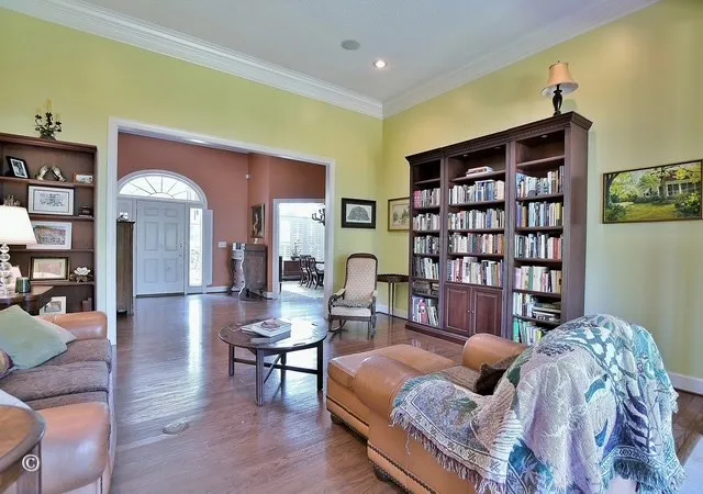 a living room with furniture and a book shelf