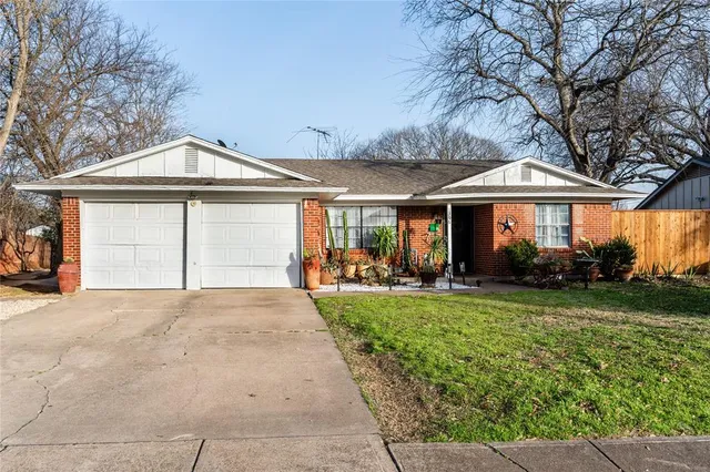 a front view of a house with yard and green space