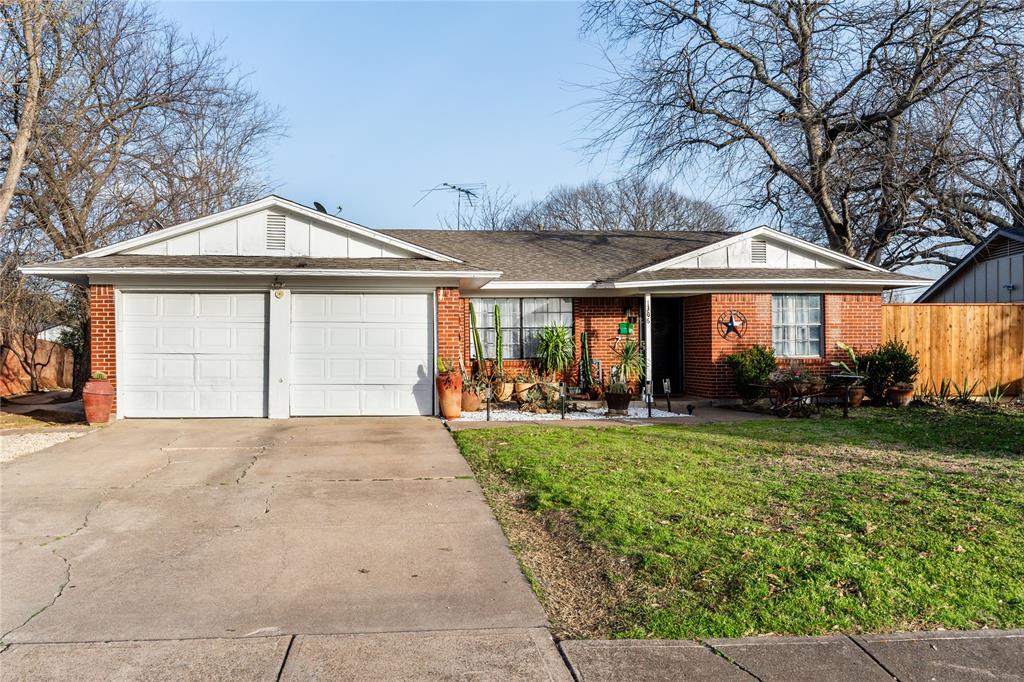 a front view of a house with yard and green space