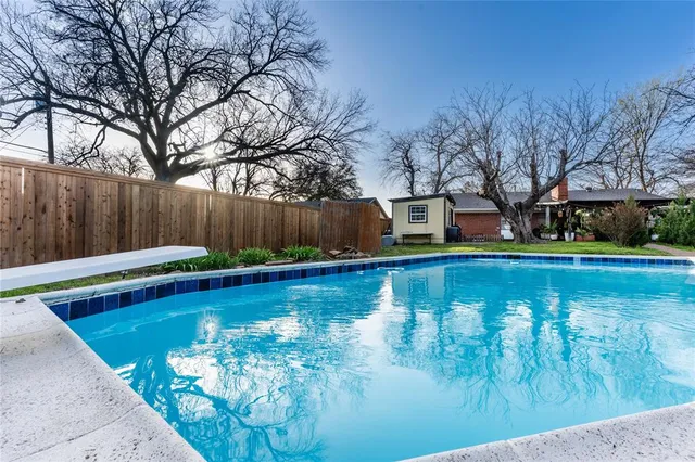 a view of swimming pool with trees in the background