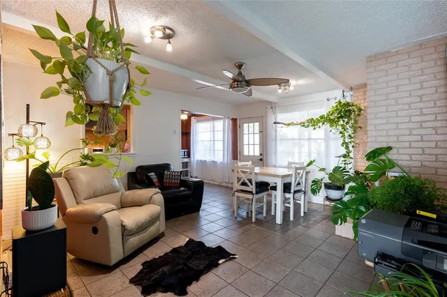 a living room with furniture potted plant and a chandelier