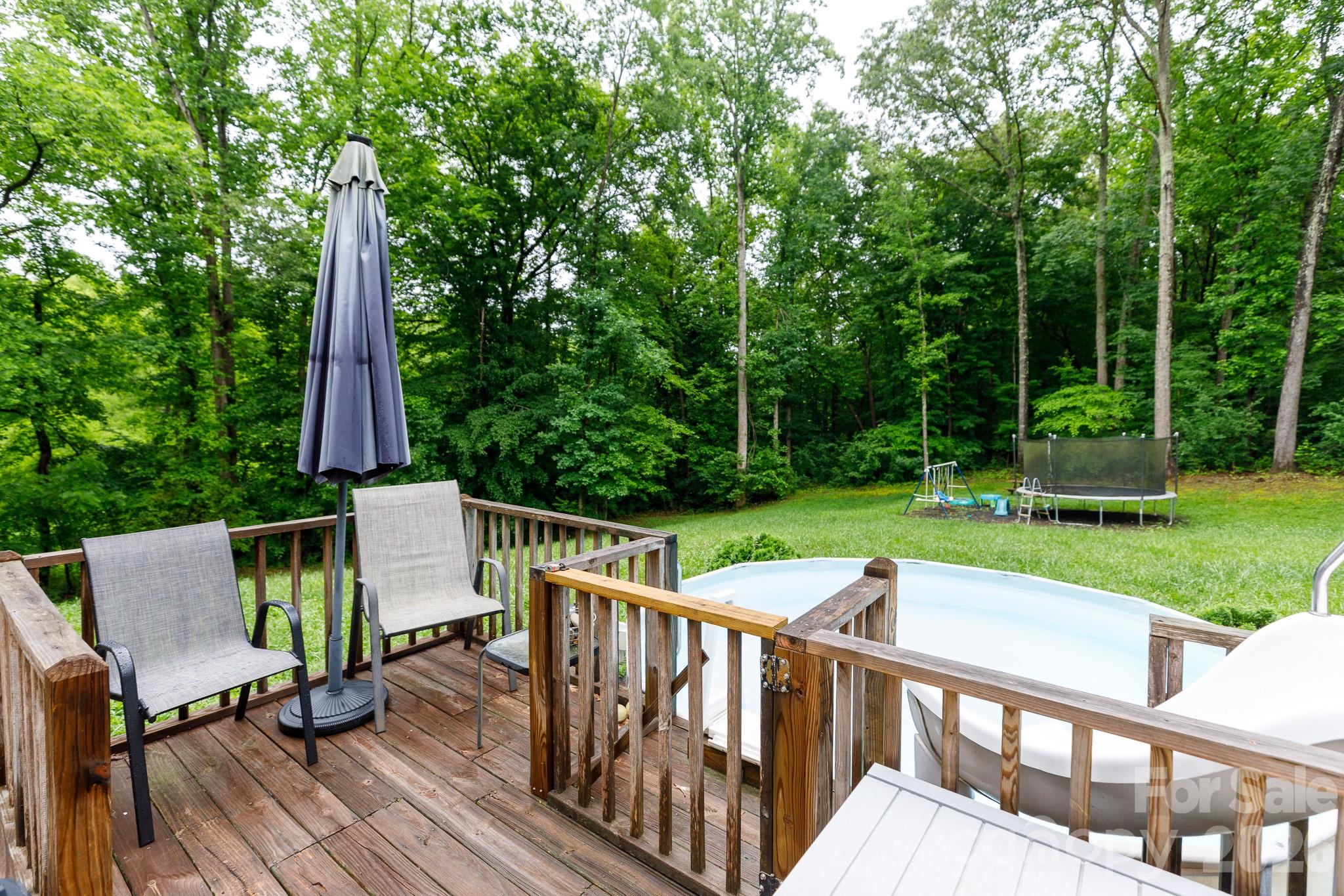 652 Sutton Spring Road York, SC 29745 - Photo 25 of 28 a view of a deck with a table and chairs with wooden floor and fence
