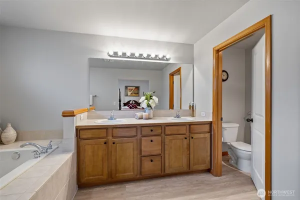 a spacious bathroom with a double vanity sink and a mirror