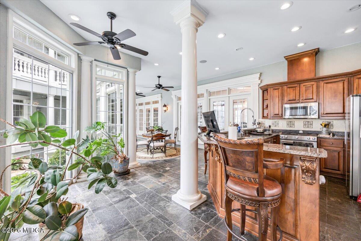 311 North Rivoli Farms Drive Macon, GA 31210 - Photo 16 of 79 a very nice looking dining room with a large window and stainless steel appliances