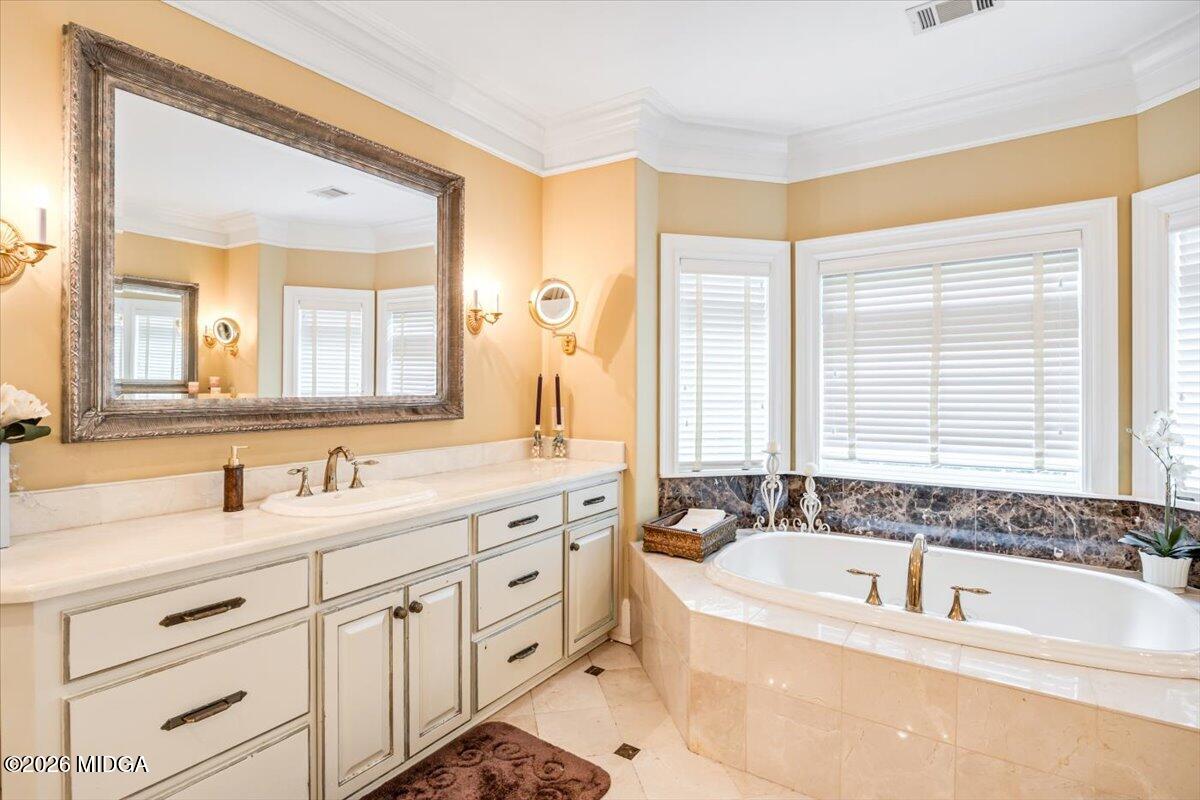 311 North Rivoli Farms Drive Macon, GA 31210 - Photo 32 of 79 a bathroom with a bathtub a double vanity sink and mirror