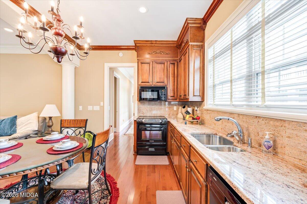 311 North Rivoli Farms Drive Macon, GA 31210 - Photo 54 of 79 a kitchen with stainless steel appliances granite countertop a sink a stove top oven a chimney a dining table and chairs