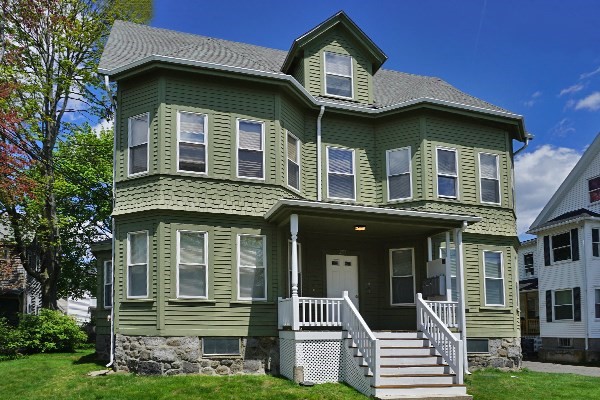 252 Ash Street, Unit 2 Waltham, MA 02453 - Photo 1 of 9 a front view of a house with a garden