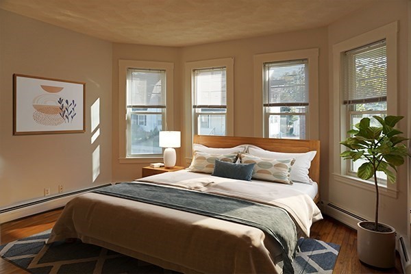 252 Ash Street, Unit 2 Waltham, MA 02453 - Photo 3 of 9 a bedroom with a bed and a window