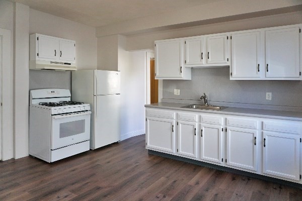 252 Ash Street, Unit 2 Waltham, MA 02453 - Photo 5 of 9 a kitchen with granite countertop white cabinets and white appliances