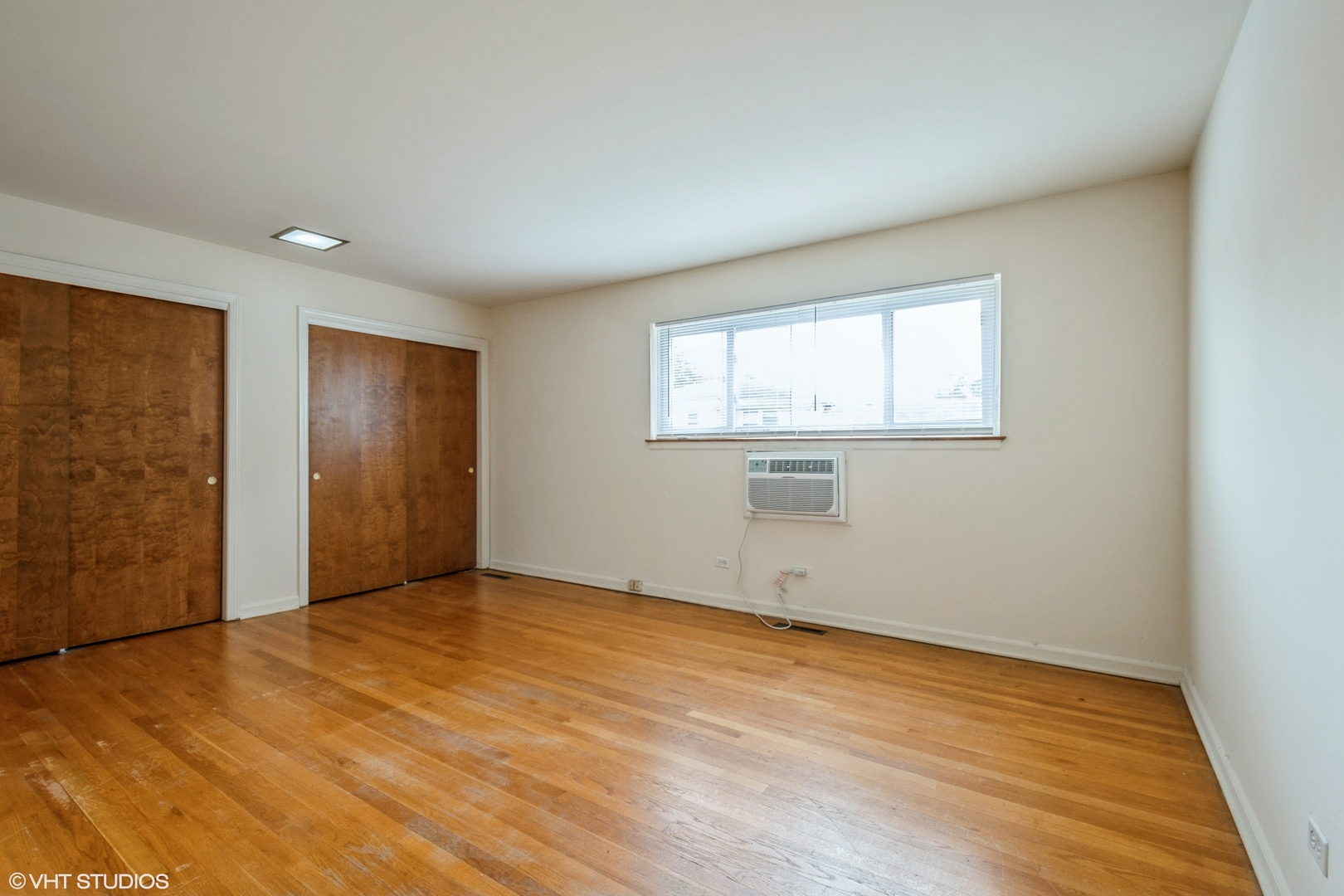 1324 Tinker Way, Unit D Glenview, IL 60025 - Photo 6 of 8 an empty room with wooden floor and windows