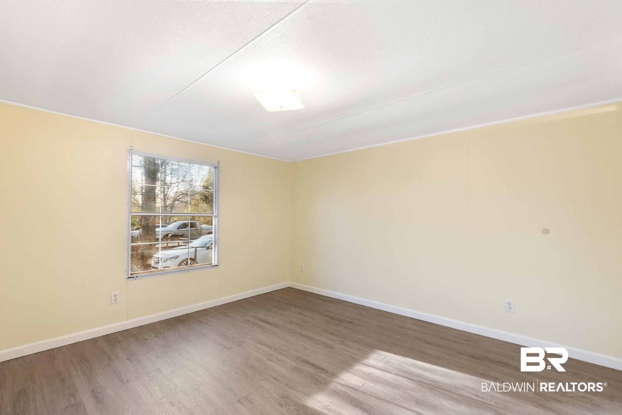 7695 Bermuda Drive Semmes, AL 36575 - Photo 24 of 27 Empty room featuring baseboards and wood finished floors
