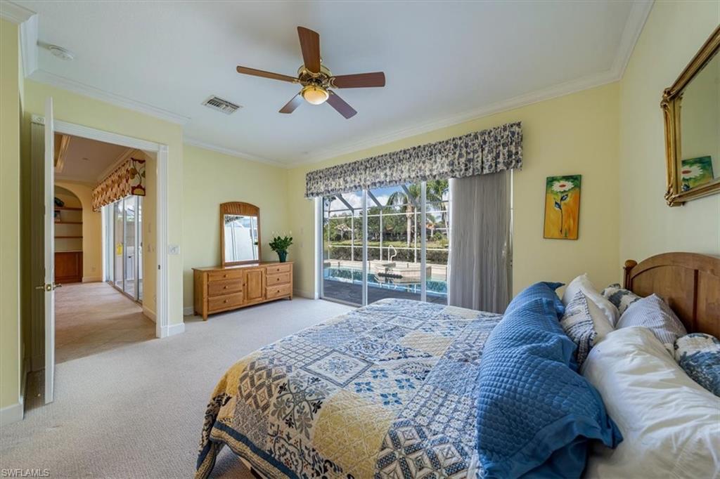 352 Steerforth Court Naples, FL 34110 - Photo 11 of 35 a living room with a bed furniture and a large window