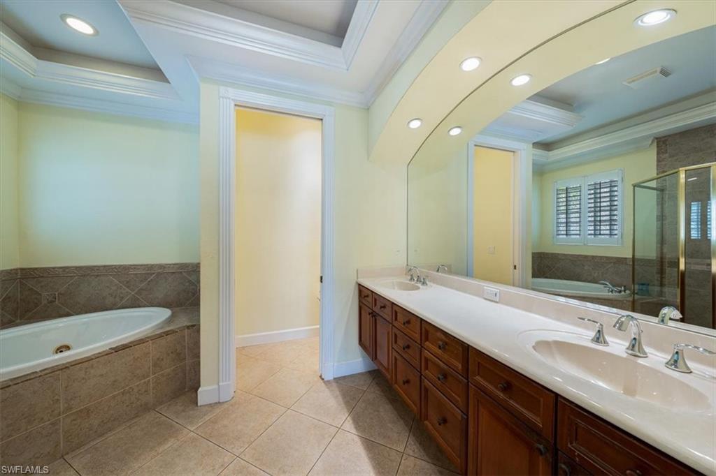 352 Steerforth Court Naples, FL 34110 - Photo 12 of 35 a spacious bathroom with a bathtub sink and mirror