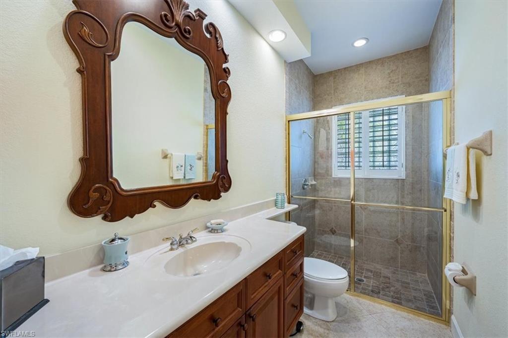 352 Steerforth Court Naples, FL 34110 - Photo 19 of 35 a bathroom with a sink a toilet and shower