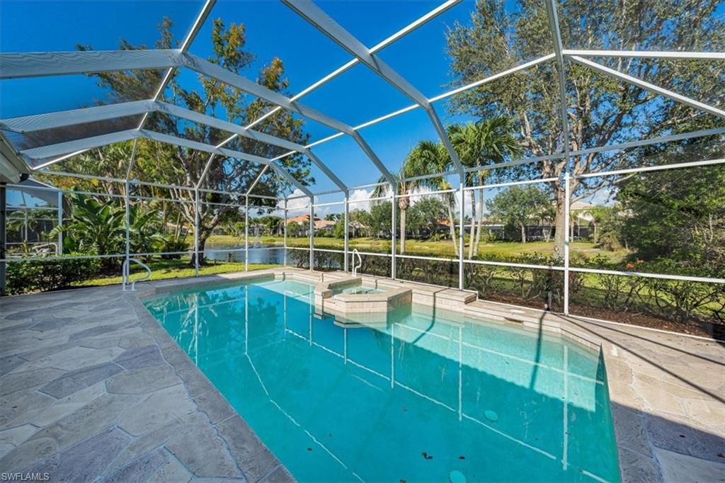 352 Steerforth Court Naples, FL 34110 - Photo 24 of 35 a view of a backyard with a swimming pool