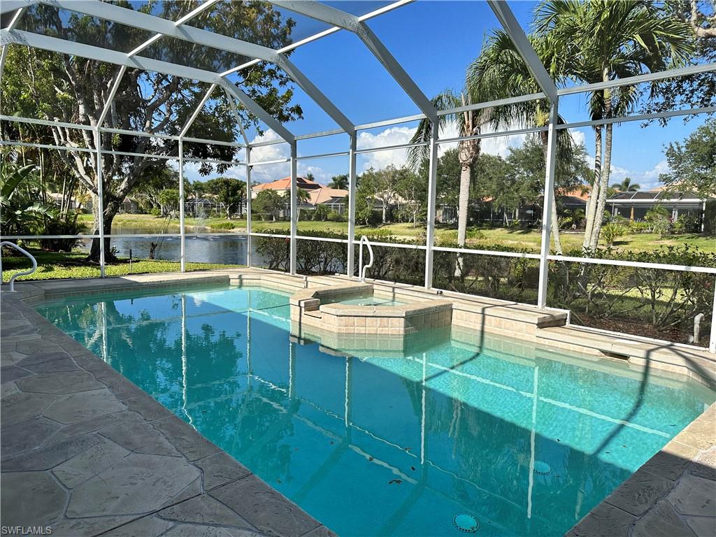 352 Steerforth Court Naples, FL 34110 - Photo 25 of 35 a view of a swimming pool with a patio and a yard