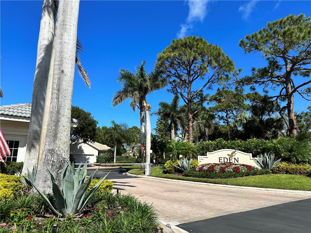 352 Steerforth Court Naples, FL 34110 - Photo 34 of 35 a view of a garden with a cars parked on the roadside