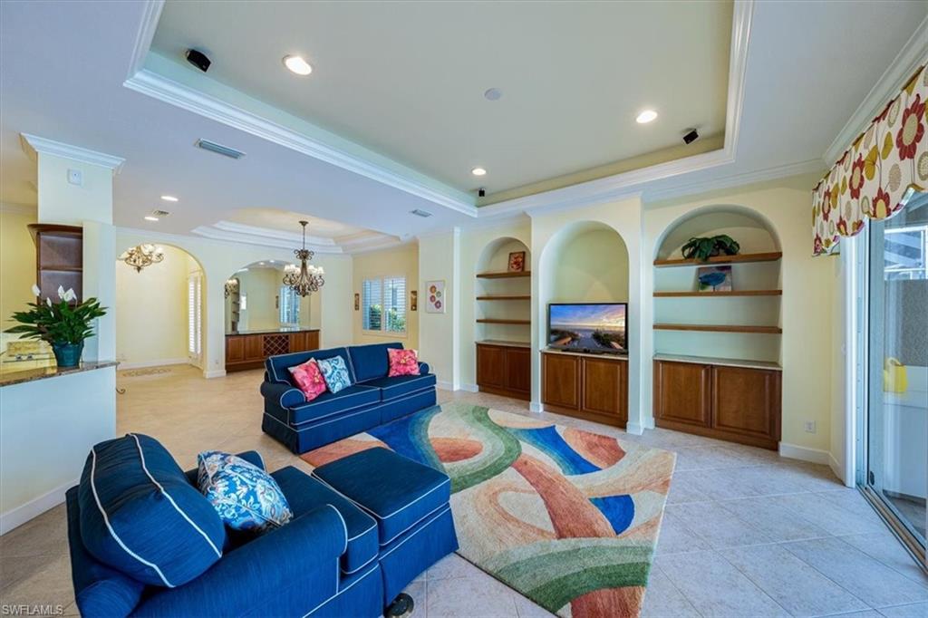 352 Steerforth Court Naples, FL 34110 - Photo 4 of 35 a living room with furniture and a flat screen tv