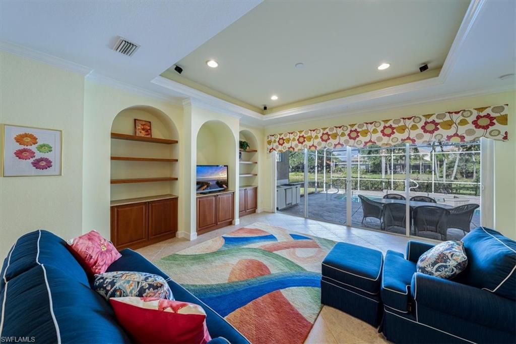 352 Steerforth Court Naples, FL 34110 - Photo 5 of 35 a living room with furniture a rug and a flat screen tv