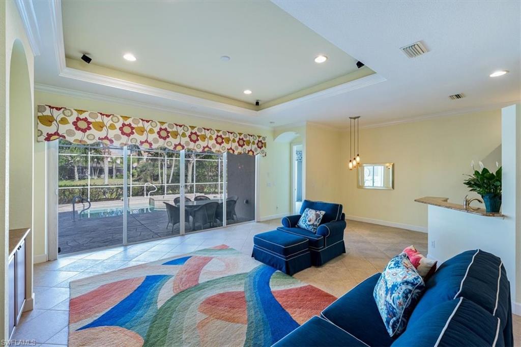 352 Steerforth Court Naples, FL 34110 - Photo 6 of 35 a living room with furniture and a flat screen tv