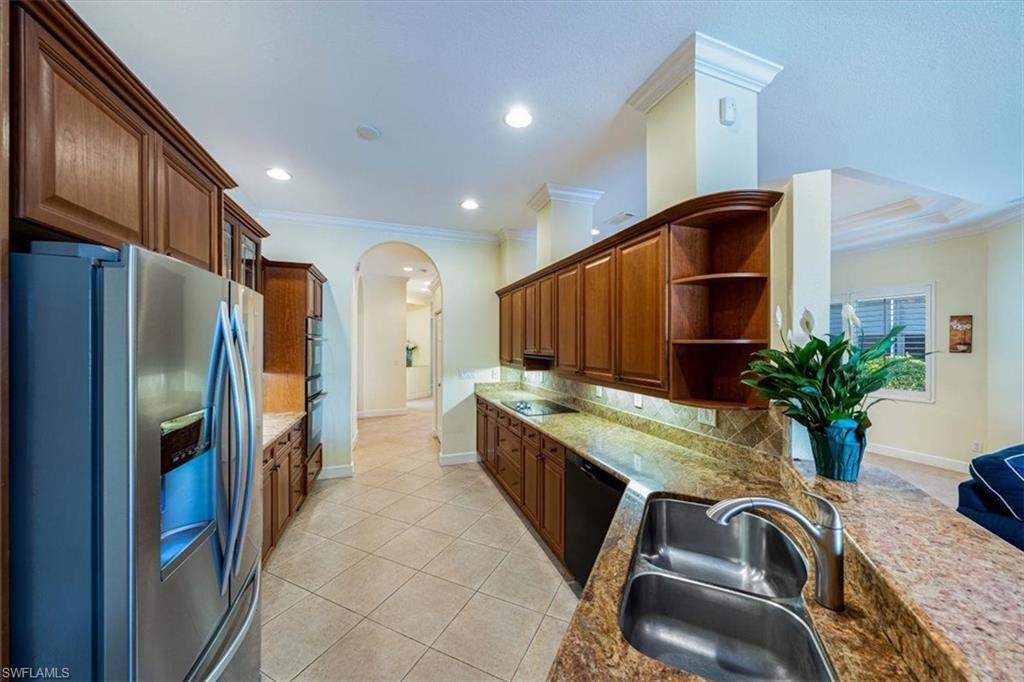 352 Steerforth Court Naples, FL 34110 - Photo 7 of 35 a open kitchen with stainless steel appliances granite countertop a sink a stove and a refrigerator